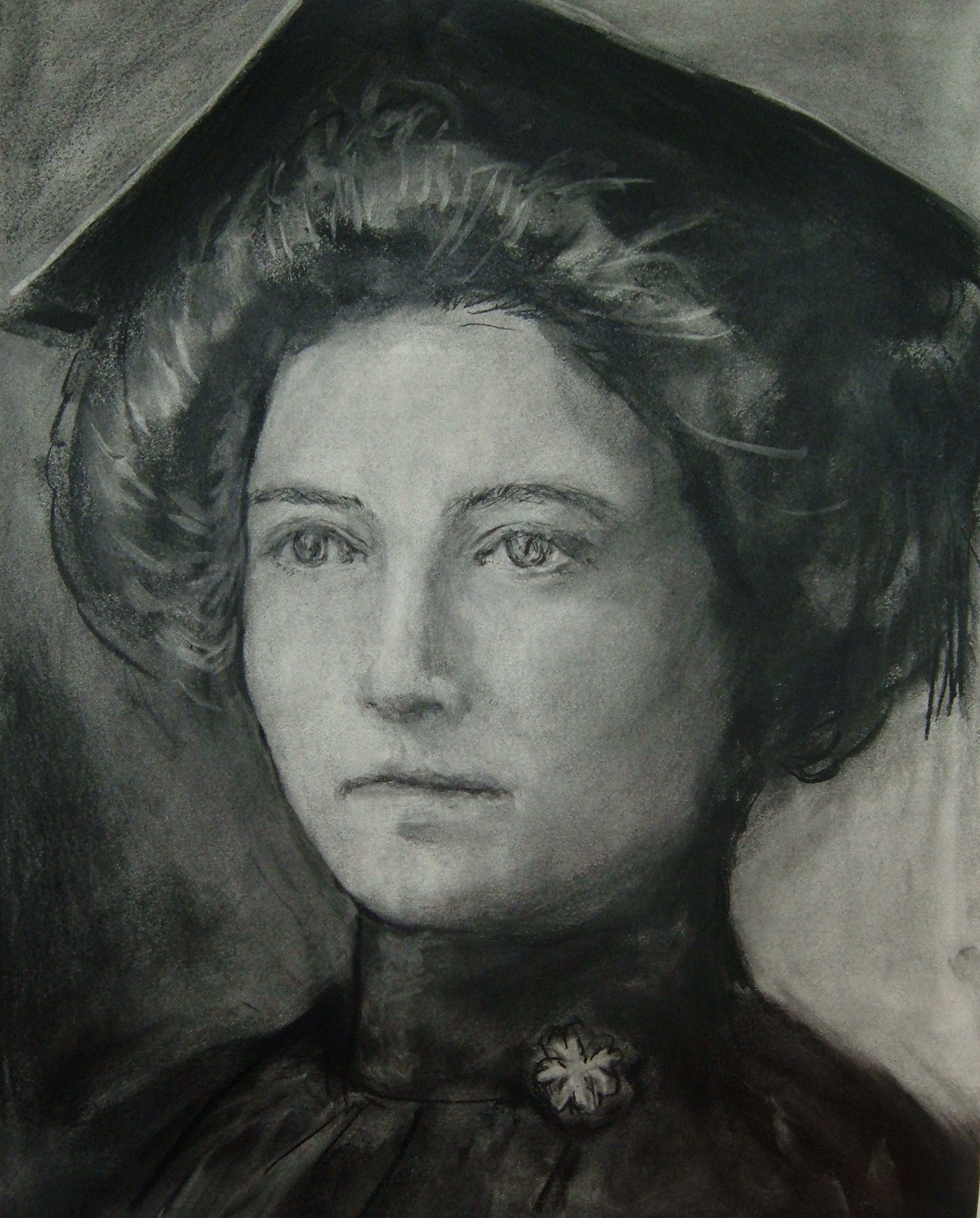 Charcoal portrait of woman graduate in cap and gown