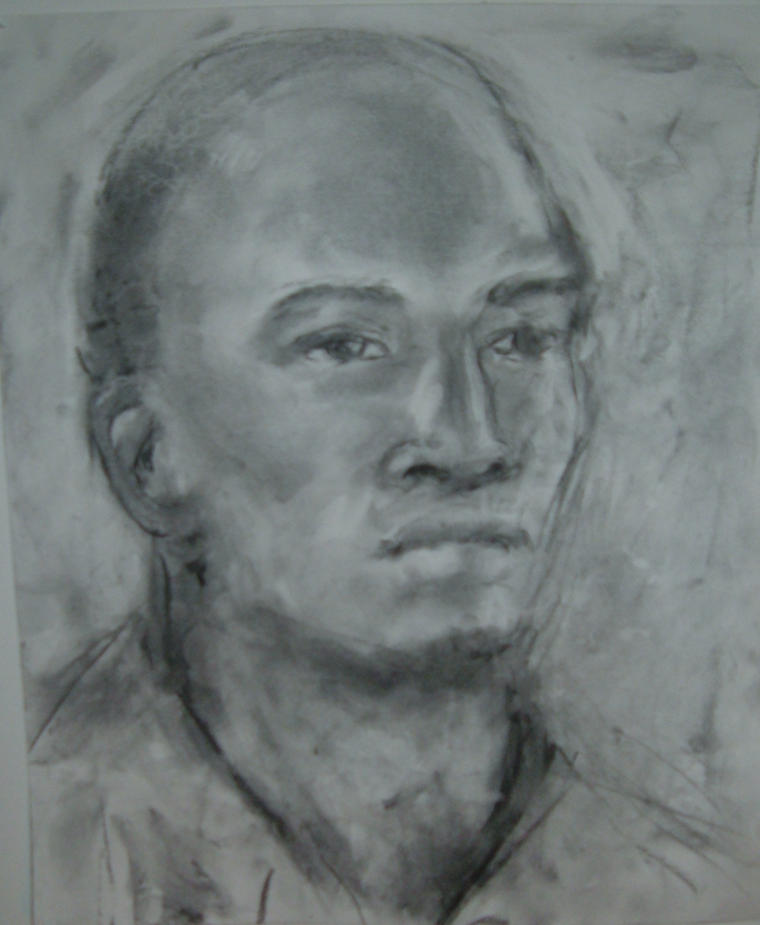 Drawing af a man in art class, charcoal